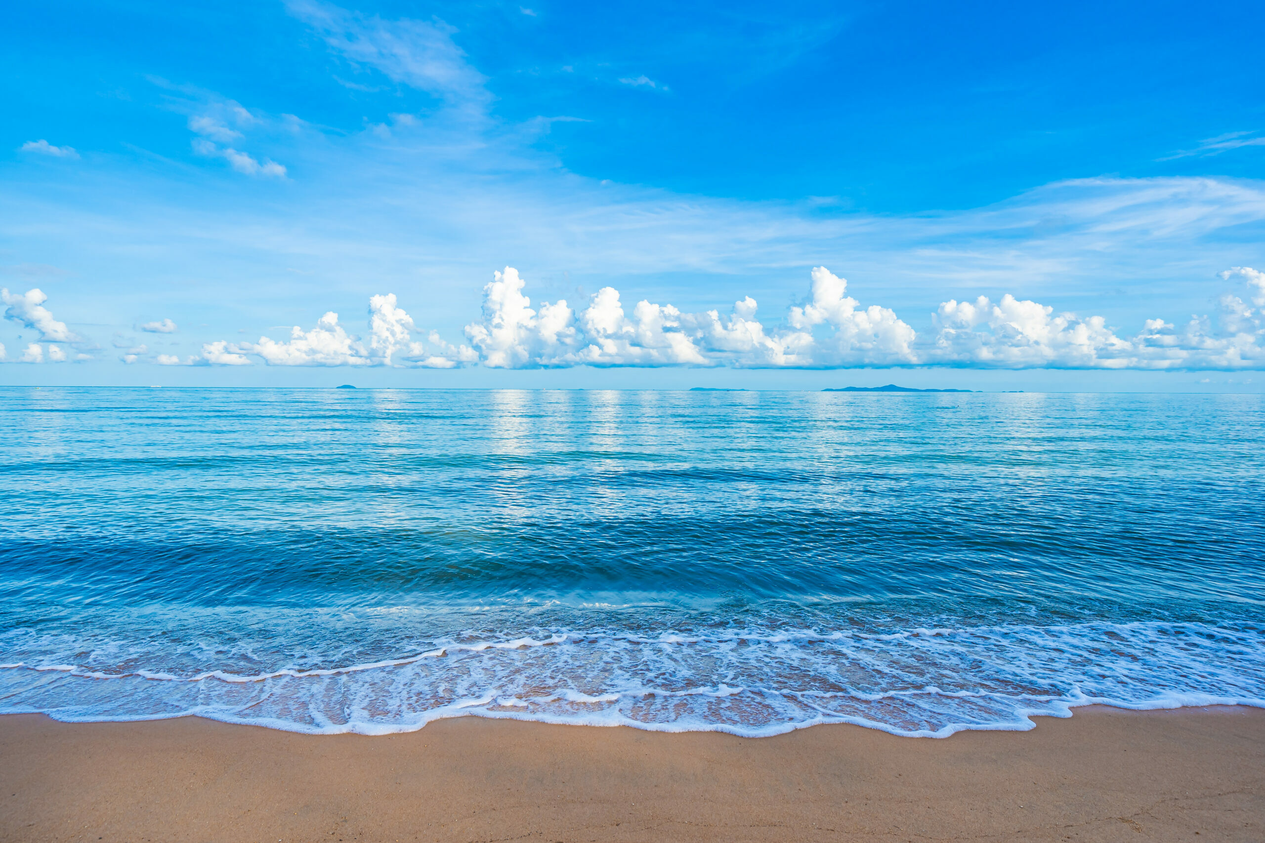 Beautiful tropical beach sea ocean with white cloud blue sky and