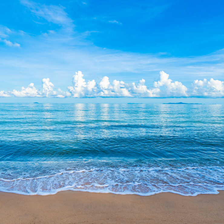 Beautiful tropical beach sea ocean with white cloud blue sky and